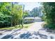 Charming home featuring a welcoming front porch, a two-car garage, and mature trees at 6026 Belle Meade Ct, Villa Rica, GA 30180