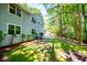 Exterior side view of house showcasing backyard with lush lawn and wooded scenery at 6026 Belle Meade Ct, Villa Rica, GA 30180