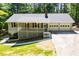 Charming home featuring a welcoming front porch, a two-car garage, and mature trees at 6026 Belle Meade Ct, Villa Rica, GA 30180