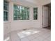 Bright sunroom with large windows offering a serene view of the surrounding trees at 6026 Belle Meade Ct, Villa Rica, GA 30180