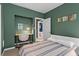 A secondary bedroom has a work area and a queen-size bed with striped bedding and an ensuite at 1421 Peachtree Ne St # 212, Atlanta, GA 30309
