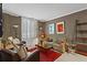 Cozy living room with arm chairs, sofa, and large windows offering ample natural light at 1421 Peachtree Ne St # 212, Atlanta, GA 30309
