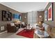Comfortable living room with plush seating, red rug, and bright natural light from windows at 1421 Peachtree Ne St # 212, Atlanta, GA 30309