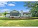 Backyard featuring a large yard, screened porch, with mature trees and landscape at 2895 Fairview Rd, Covington, GA 30016