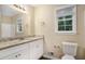 Updated bathroom featuring granite counters, white vanity, and modern fixtures at 2895 Fairview Rd, Covington, GA 30016