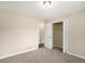Bedroom features neutral carpet, access to a large closet, and a view into another room at 2895 Fairview Rd, Covington, GA 30016