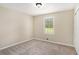 Bedroom featuring neutral walls, plush carpet, and a window that provides natural light at 2895 Fairview Rd, Covington, GA 30016