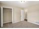 Bedroom features neutral carpet, access to a large closet, and a view into another room at 2895 Fairview Rd, Covington, GA 30016