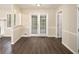 Dining area with dark wood-look flooring, natural light, and convenient access to outdoors at 2895 Fairview Rd, Covington, GA 30016