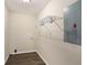 Functional laundry room with overhead storage and durable, modern flooring at 2895 Fairview Rd, Covington, GA 30016