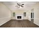 Bright living room featuring a cozy fireplace, wood-look floors, and a ceiling fan at 2895 Fairview Rd, Covington, GA 30016