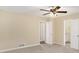 Spacious main bedroom with ceiling fan, carpet, and access to an ensuite bathroom at 2895 Fairview Rd, Covington, GA 30016
