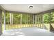Screened porch with a view of the backyard's mature trees and landscape at 2895 Fairview Rd, Covington, GA 30016