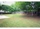 Expansive backyard with mature trees, offering plenty of space for outdoor activities at 4130 Providnce Square, Alpharetta, GA 30009