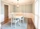 Elegant dining room featuring hardwood floors, decorative wainscoting, and a classic chandelier at 4130 Providnce Square, Alpharetta, GA 30009