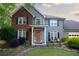 Charming two-story home featuring a well-maintained lawn, a combination brick and vinyl facade, and a welcoming front porch at 4130 Providnce Square, Alpharetta, GA 30009