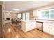 Open kitchen with white cabinets, stainless steel appliances, and a central island perfect for cooking and entertaining at 4130 Providnce Square, Alpharetta, GA 30009