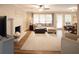 Bright living room features a decorative fireplace, hardwood floors, and large windows, creating a warm and inviting space at 4130 Providnce Square, Alpharetta, GA 30009