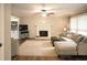 Inviting living room with a fireplace and large windows offering natural light and views, plus comfortable seating arrangement at 4130 Providnce Square, Alpharetta, GA 30009