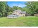 Spacious backyard featuring a deck with stairs and a round above-ground swimming pool, perfect for outdoor enjoyment at 12510 Georgia 36, Covington, GA 30014