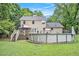 Spacious backyard featuring a deck with stairs and a round above-ground swimming pool, perfect for outdoor enjoyment at 12510 Georgia 36, Covington, GA 30014