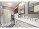 Bright bathroom featuring a modern vanity with dual sinks and glass enclosed shower at 12510 Georgia 36, Covington, GA 30014