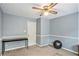 Spare bedroom with light blue walls, carpeted flooring, and a black desk at 12510 Georgia 36, Covington, GA 30014