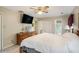 Bedroom with a ceiling fan, a TV, a dresser, and access to a private bathroom at 12510 Georgia 36, Covington, GA 30014