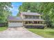 Charming two-story home featuring a covered front porch, attached garage, and well-manicured landscaping at 12510 Georgia 36, Covington, GA 30014
