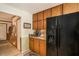 Traditional kitchen with wood cabinets and a black refrigerator at 12510 Georgia 36, Covington, GA 30014