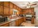 Traditional kitchen with wood cabinets, stainless steel appliances, and a ceiling fan at 12510 Georgia 36, Covington, GA 30014