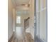 Bright entryway with hardwood floors, staircase, and a glass-paneled door offering a glimpse of the outdoor scenery at 408 Westmarch Cir, Loganville, GA 30052