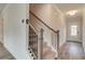Welcoming entryway featuring hardwood floors, staircase with dark metal spindles, and a bright white door with glass panes at 408 Westmarch Cir, Loganville, GA 30052