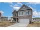 Inviting two-story home with stone and siding, a two-car garage, and landscaping in a desirable neighborhood at 408 Westmarch Cir, Loganville, GA 30052