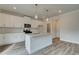 Contemporary kitchen featuring white cabinets, granite countertops, stainless appliances, and an island with pendant lighting at 408 Westmarch Cir, Loganville, GA 30052