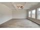Bright living room featuring hardwood floors, a coffered ceiling, and large windows offering scenic neighborhood views at 408 Westmarch Cir, Loganville, GA 30052