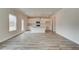 Sunlit living space with hardwood floors leading to a modern kitchen with an island, complemented by a view of the outdoors at 408 Westmarch Cir, Loganville, GA 30052