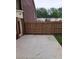 Back patio with a wooden fence and a gate leading to the backyard at 6210 Douglas Manor Ct, Douglasville, GA 30134