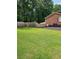 Large backyard with a newly installed wooden fence and mature trees at 6210 Douglas Manor Ct, Douglasville, GA 30134