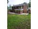 Expansive brick home exterior with a lush green lawn and fenced yard at 6210 Douglas Manor Ct, Douglasville, GA 30134