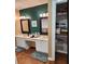 Bathroom featuring double sinks and storage with a closet area with organized shelving at 6210 Douglas Manor Ct, Douglasville, GA 30134