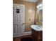 Restroom featuring a white door with a gender sign, mirror, and sink at 6210 Douglas Manor Ct, Douglasville, GA 30134