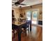 Inviting dining room features hardwood floors and a modern ceiling fan at 6210 Douglas Manor Ct, Douglasville, GA 30134