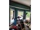 Workout room with natural light, modern equipment, and green accent walls at 6210 Douglas Manor Ct, Douglasville, GA 30134
