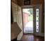 Bright foyer with hardwood floors and door with decorative stained glass offering a welcoming entrance to the home at 6210 Douglas Manor Ct, Douglasville, GA 30134