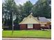 Charming brick home with a well-manicured lawn, black fence, and mature landscaping at 6210 Douglas Manor Ct, Douglasville, GA 30134