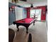 Spacious game room featuring a pool table, ceiling fan, and adjacent seating area by a window at 6210 Douglas Manor Ct, Douglasville, GA 30134