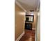 A hallway featuring hardwood floors, detailed molding, and neutral paint, exuding sophistication and timeless appeal at 6210 Douglas Manor Ct, Douglasville, GA 30134