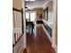 Hallway view to a dining area, with wood floors and neutral walls at 6210 Douglas Manor Ct, Douglasville, GA 30134