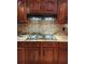 Kitchen showcasing granite countertops, tile backsplash and wood cabinets at 6210 Douglas Manor Ct, Douglasville, GA 30134